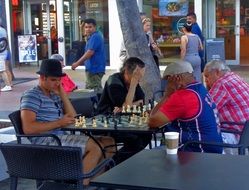 men play chess on the street in Miami