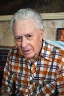 Portrait of old grey haired man with big forehead