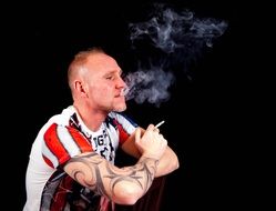 smoking man with a tattoo