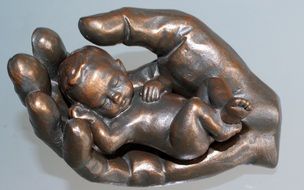 Child in Hand Bronze Statue