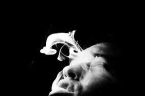 Black and white photo of the man blowing smoke