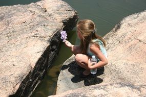 girl with flower on the shore