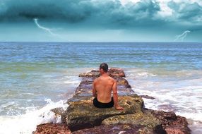 man sitting on the pier