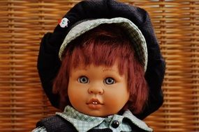 Children's toy in the form of a doll in a cap and suit