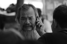 Asian with a smartphone in black and white image