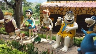 Flintstone family figures in an amusement park