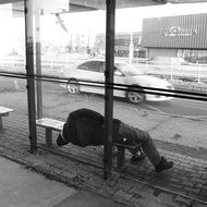 Homless Man Sleeping in bus station