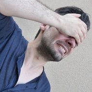 portrait of a man with strong headache