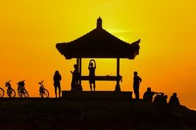 Silhouette of People and gazebo at Sunset