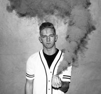 portrait of a young man with a smoke bomb