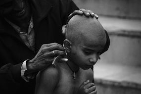 traditional shaving of the head of a child in the Buddhist religion