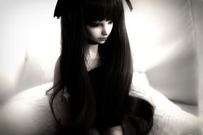 black and white photo of a doll with black hair