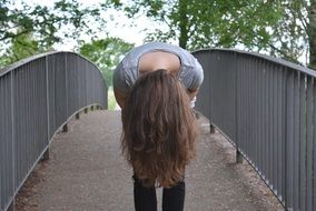 Girl Upside Down Hair on a bridge