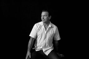black and white portrait of a man on a black background