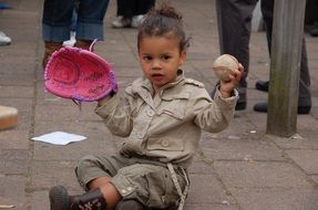 child in a baseball glove with a ball