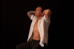 man with tattoos in a photo studio