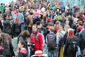 crowd of people at a rally with backpacks