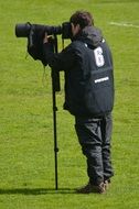 photographer on a green field