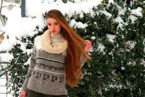 girl with long hair among the winter landscape