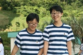 two teenagers with glasses and striped t-shirts