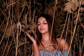 beautiful girl among the cane at dusk