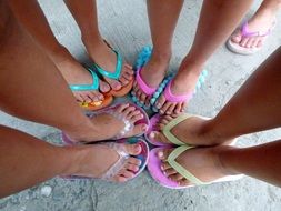 Feet of child girls in flip flop shoes