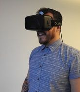 man is playing with virtual reality glasses