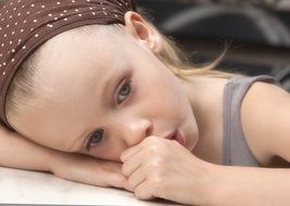 child with finger in mouth