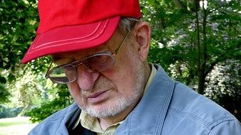 old man in a red cap