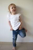 Girl in Jeans near the wall