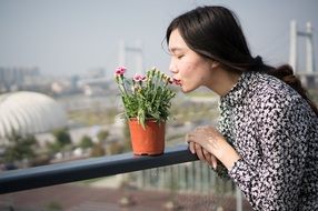 portrait of asian model kissing flowers