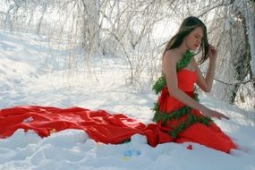 girl in a scarlet dress among the snow