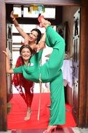 two happy Girls doing Gymnastics exercises in doorway