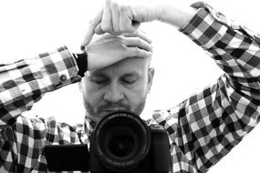 black and white image of a photographer with a camera