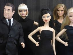 Barbie dolls in black dresses