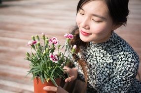 smiling model with potted flowers