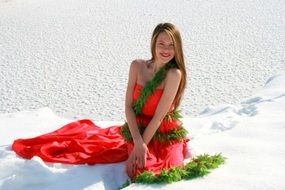 beautiful girl in a scarlet dress among the snow