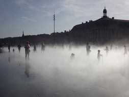 black and white photo of people on the fountain in france