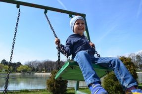 swinging little boy