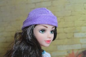 beautiful doll in a purple hat
