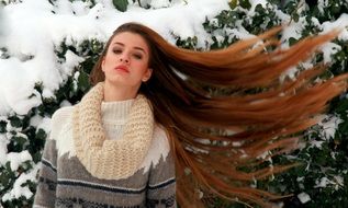 woman with long hair in winter garden