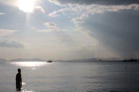 water under the sunbeams on a background of clouds