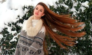 girl with long hair in winter garden