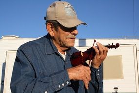 old man with a little violin on the street