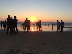 people on the evening beach in india