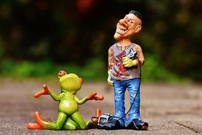 frog kneeling beside the tattooist