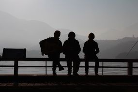silhouette of people on the lake