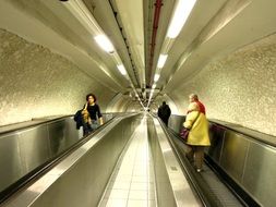 people on the escalator in the metro