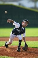 A boy catches a ball with a baseball glove