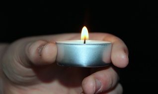 small candle in hand